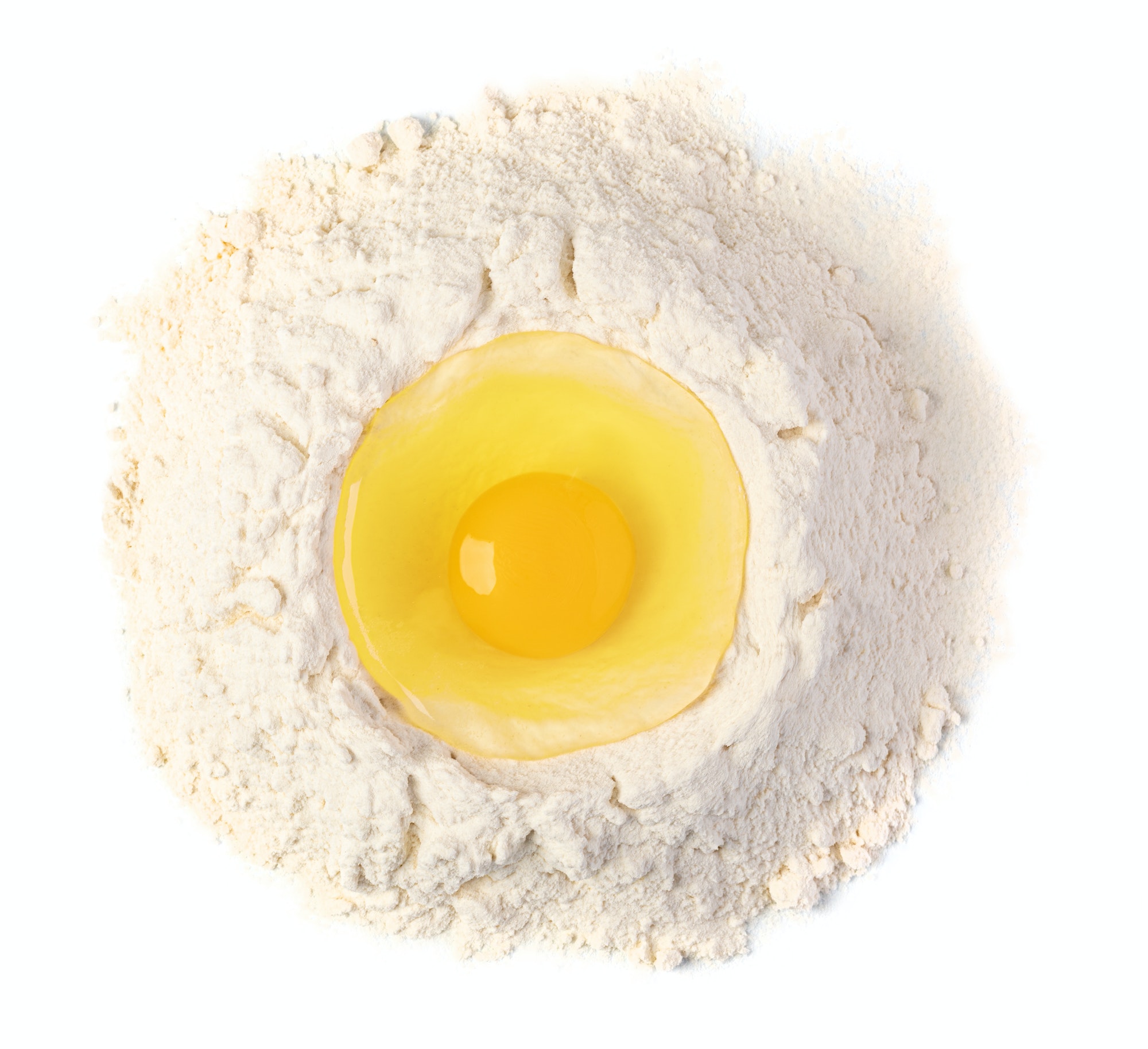 Broken egg on flour